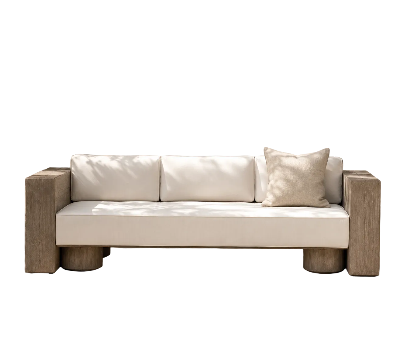 A modern outdoor sofa with thick cream cushions and chunky light wood arms and legs, set against a neutral beige wall with soft leaf shadows.